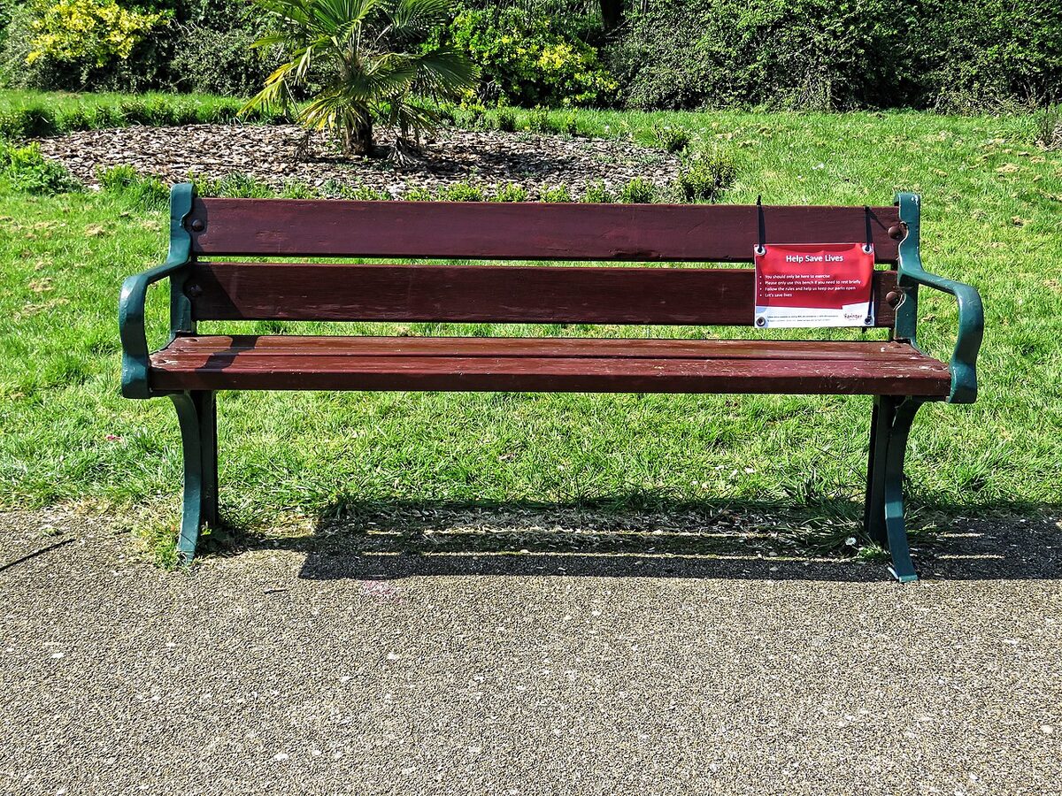 Empty park bench symbolizing isolation and loneliness