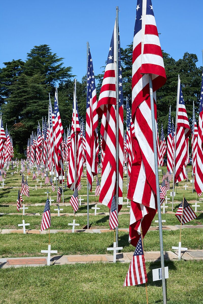 American flags on veteran graves during Memorial Day ceremony